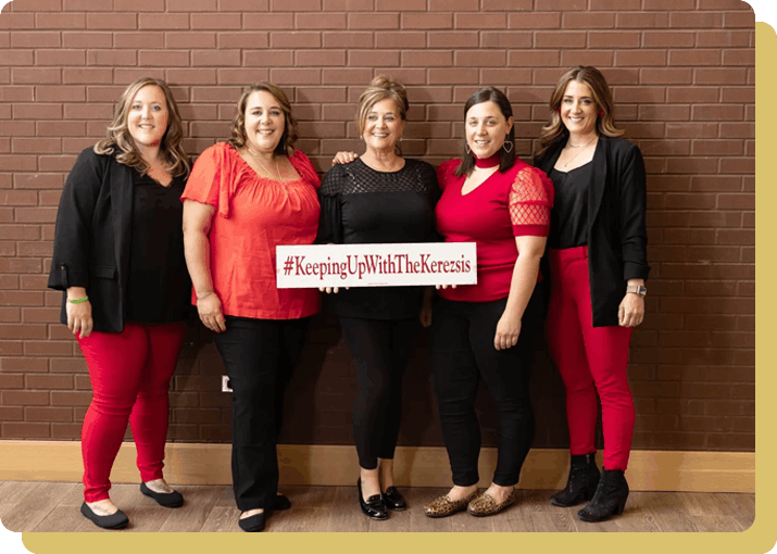 Five women smiling, holding hashtag sign